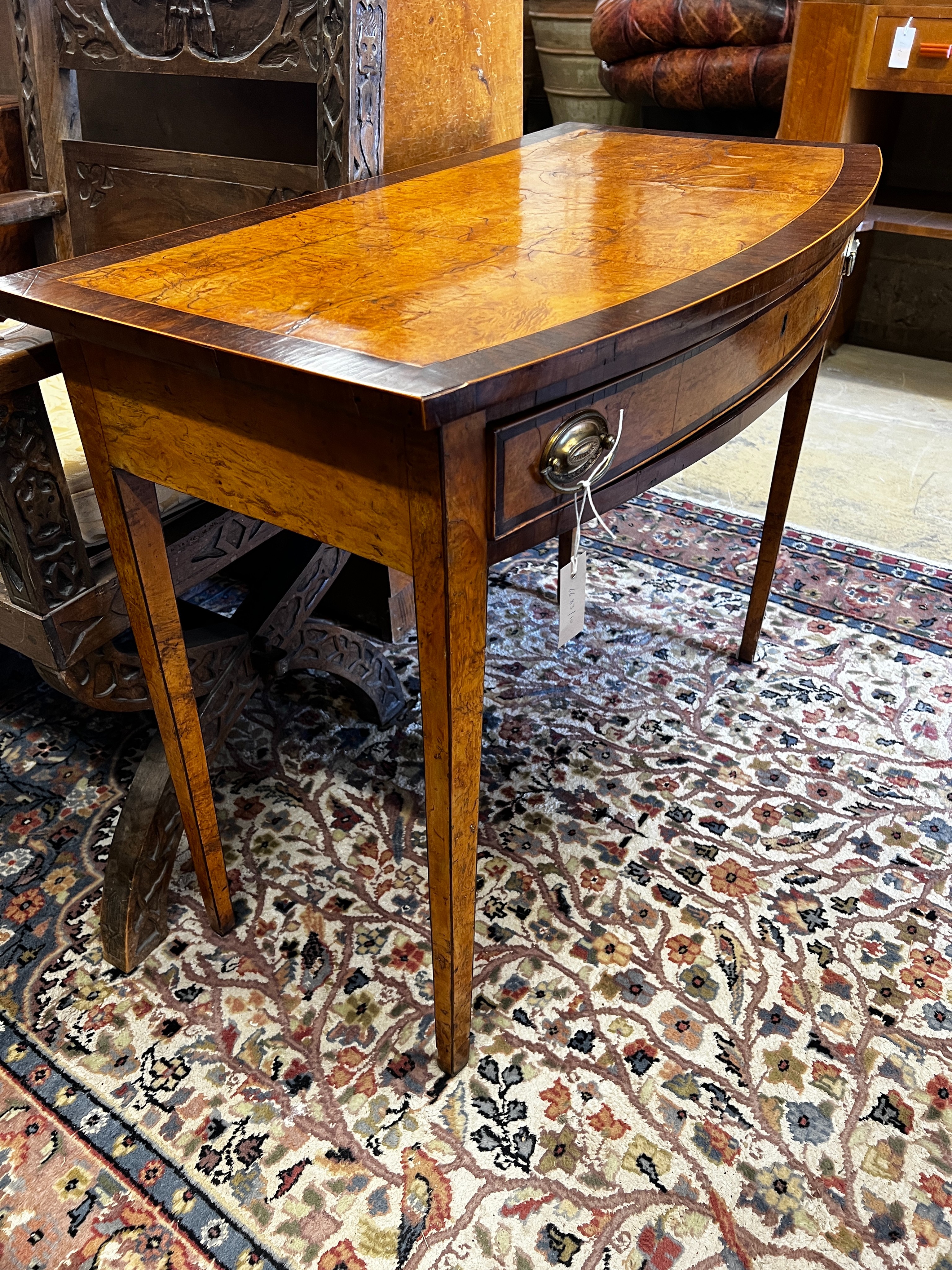 A George III rosewood banded bird's eye maple bowfront side table, width 91cm, depth 49cm, height 76cm